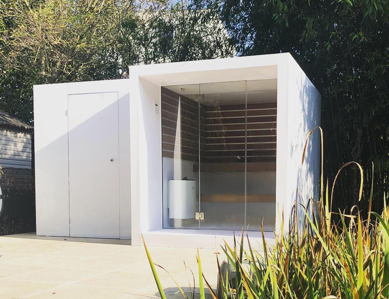 White outdoor sauna with shower room