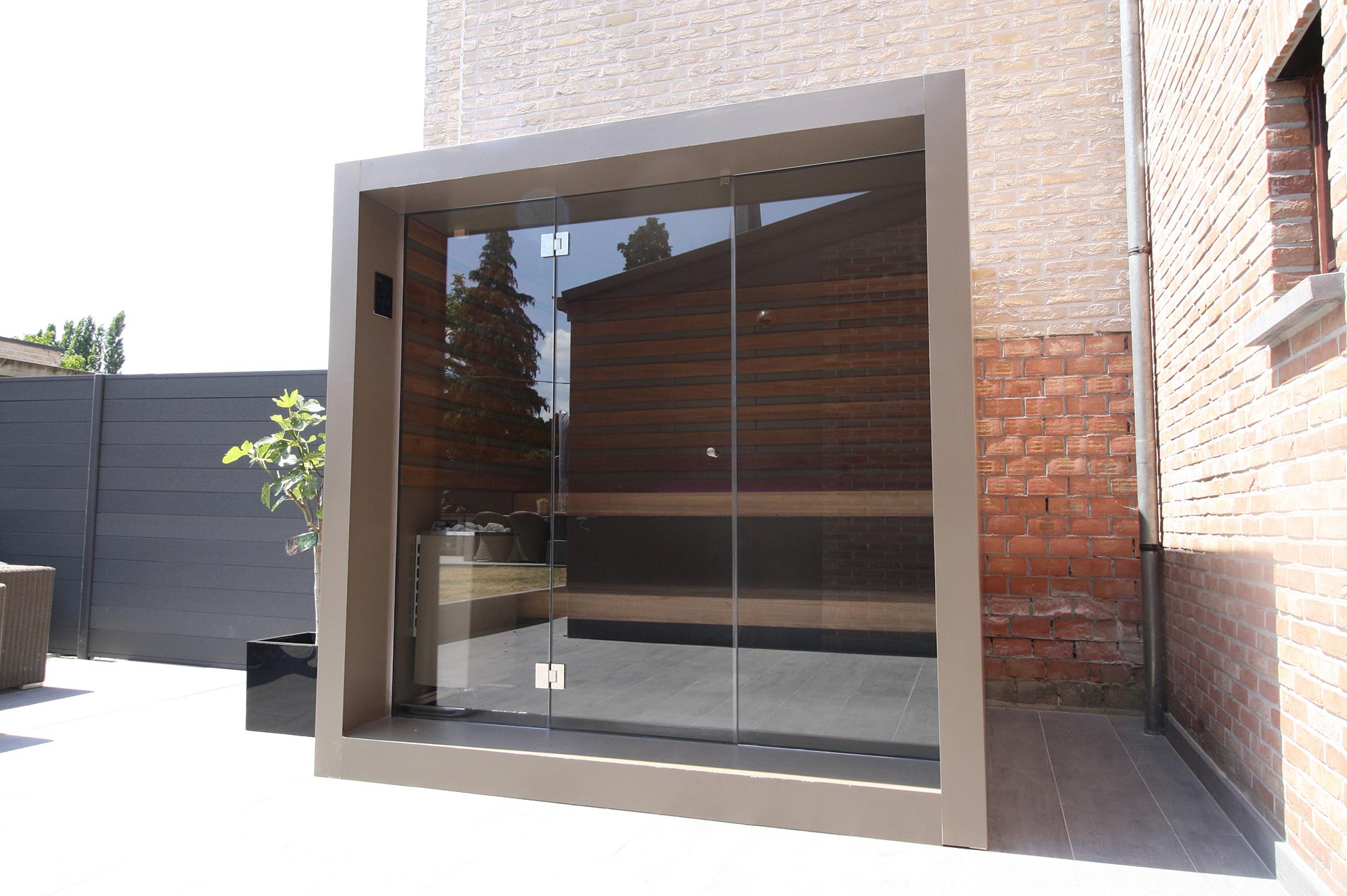 Image shows one of Thermalux's premium outdoor saunas in a garden setting. Thermalux UK are suppliers of Premium Outdoor Saunas, Luxury Outdoor Saunas, and Aluminium Finish Saunas like this one.